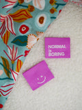 Label 'Normal is boring paars'